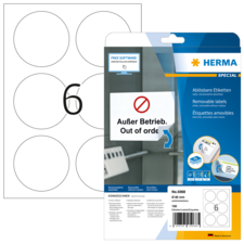Ein Blatt mit sechs runden, leeren Etiketten und einer Verpackung für ablösbare Etiketten von Herma, die die Aufschrift "Außer Betrieb" enthält.
