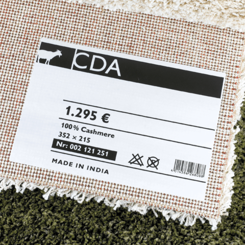 Etikett eines Cashmere-Produkts mit Preis von 1.295 €, Größe 352 x 215 cm, hergestellt in Indien.